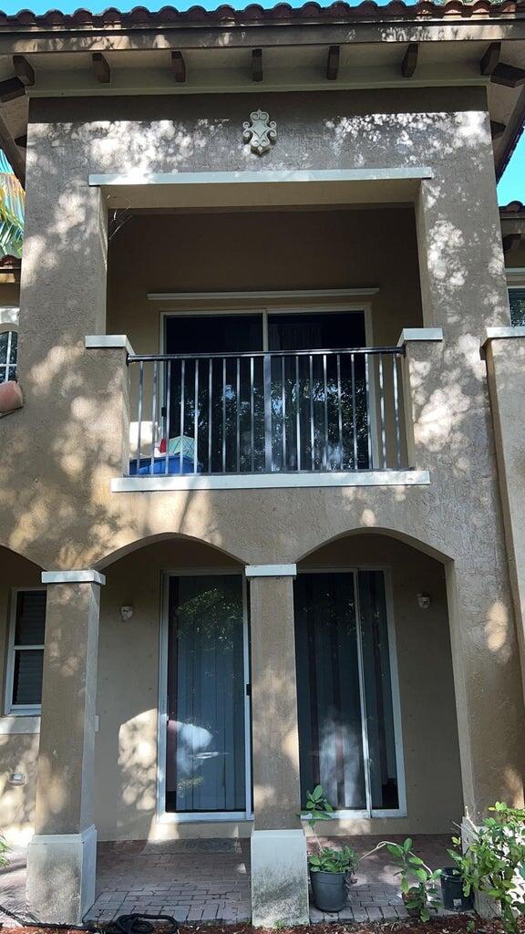 rear view of property featuring a balcony