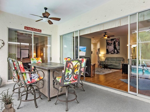 view of patio / terrace with an outdoor bar and ceiling fan