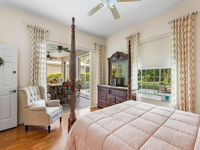 bedroom with ceiling fan, hardwood / wood-style floors, multiple windows, and access to outside