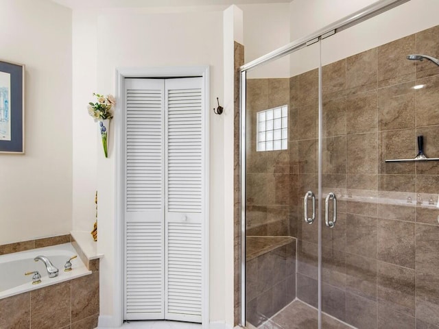 bathroom with shower with separate bathtub