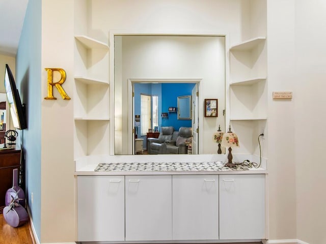 kitchen featuring white cabinets and hardwood / wood-style flooring