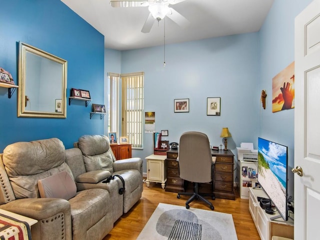 home office featuring ceiling fan and light hardwood / wood-style flooring