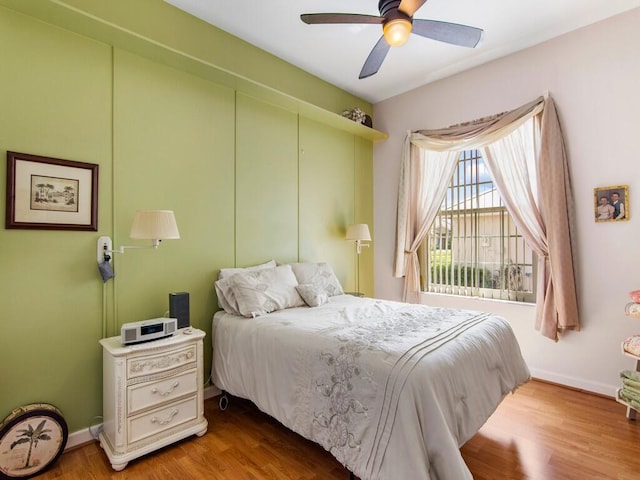 bedroom with ceiling fan and light hardwood / wood-style flooring