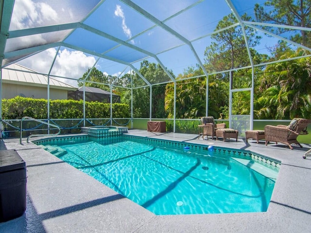 view of pool featuring a lanai, a patio area, and an in ground hot tub