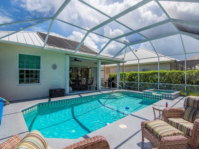 view of pool with a patio area, glass enclosure, an outdoor living space, ceiling fan, and an in ground hot tub