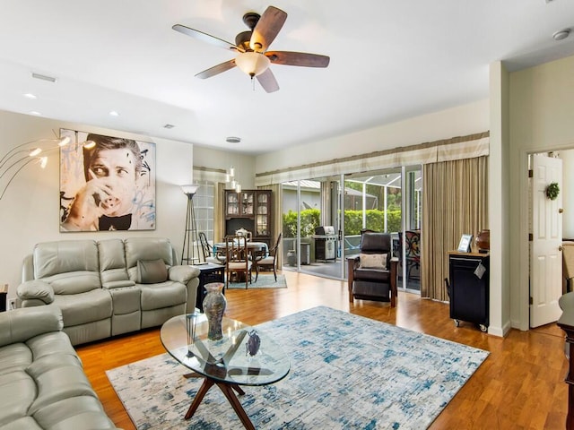 living room featuring ceiling fan and light wood-type flooring