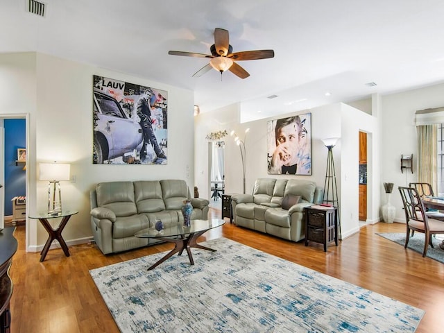 living room featuring wood-type flooring and ceiling fan