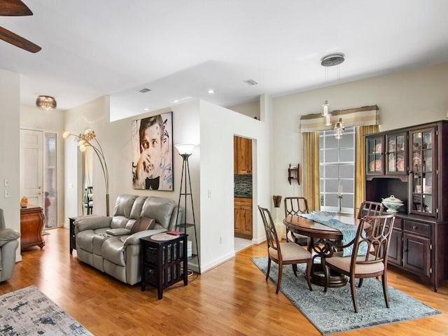 dining room featuring wood-type flooring and ceiling fan