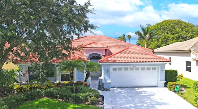 mediterranean / spanish home with a garage