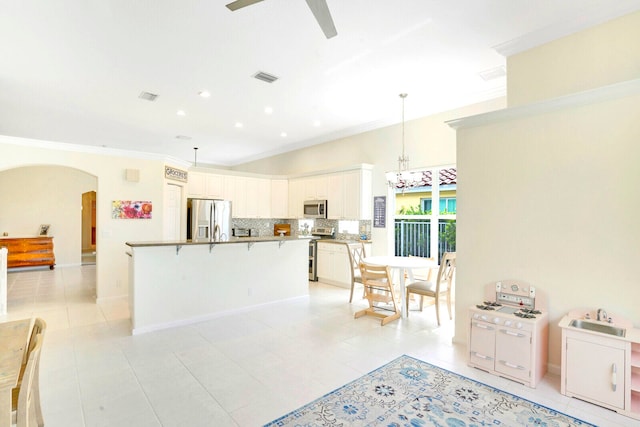 dining space featuring tile patterned floors, crown molding, and ceiling fan with notable chandelier