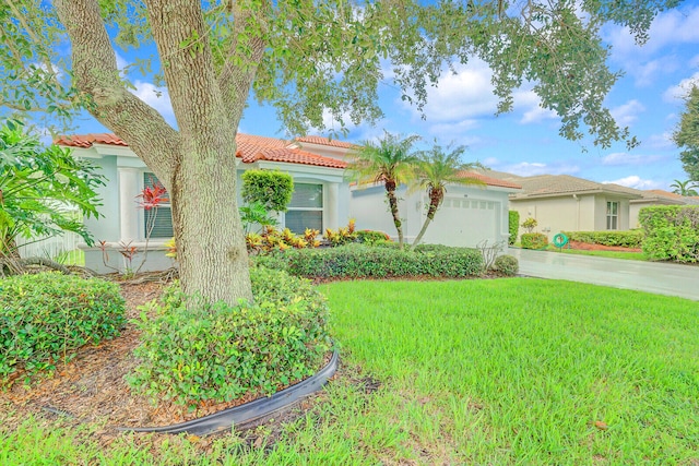 view of front of home with a front yard and a garage