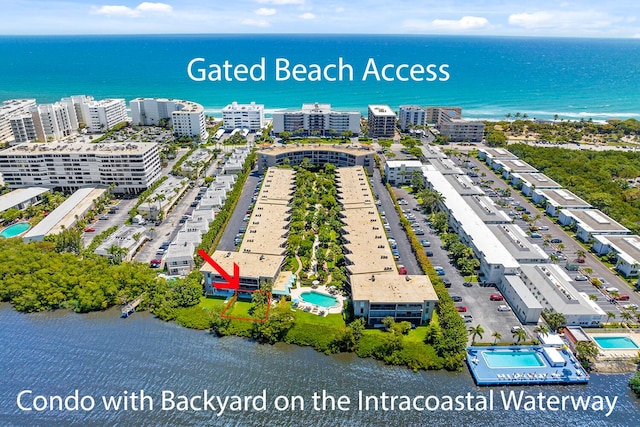 drone / aerial view with a water view and a view of the beach