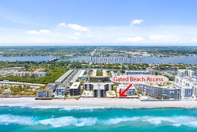 bird's eye view with a water view and a view of the beach