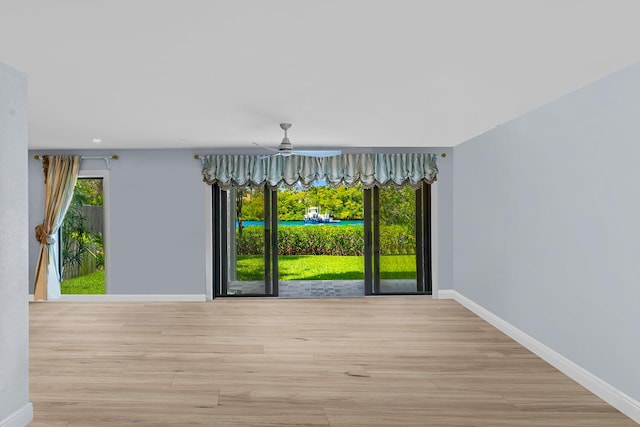 unfurnished dining area with light hardwood / wood-style flooring and ceiling fan