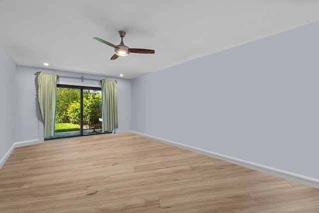 empty room featuring ceiling fan and light hardwood / wood-style floors