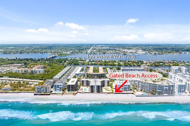 birds eye view of property featuring a water view and a view of the beach