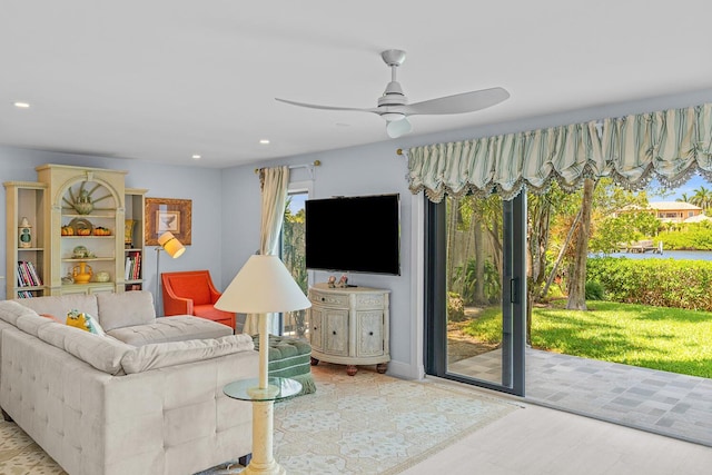 living room with light wood-type flooring and ceiling fan