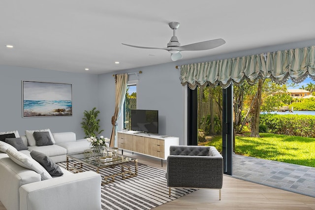 living room featuring light wood-type flooring and ceiling fan