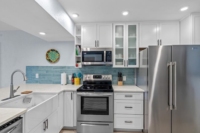 kitchen with white cabinetry, sink, and stainless steel appliances