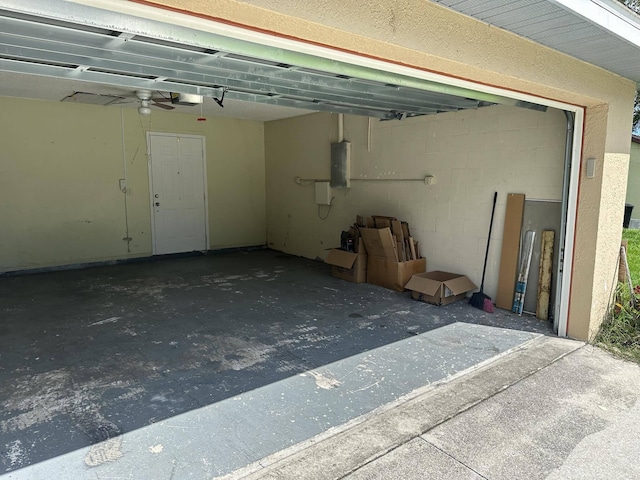 garage with electric panel and a garage door opener