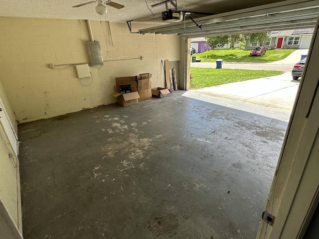 garage featuring electric panel and a garage door opener