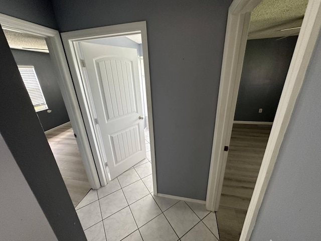 corridor featuring light tile patterned floors