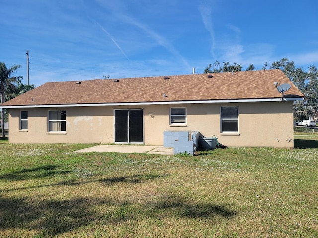 rear view of house with a yard