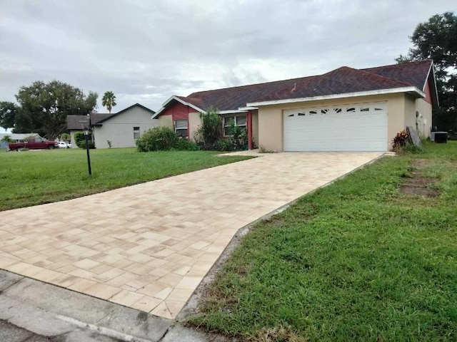 ranch-style home with a garage and a front lawn