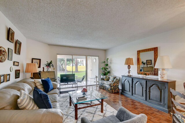 living room featuring parquet flooring and a textured ceiling