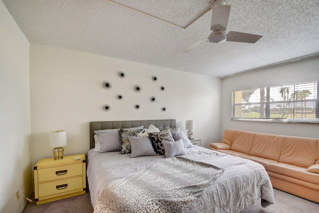 bedroom featuring carpet floors, a textured ceiling, and ceiling fan