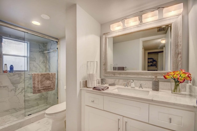 bathroom featuring a shower with door, vanity, tile patterned floors, and toilet