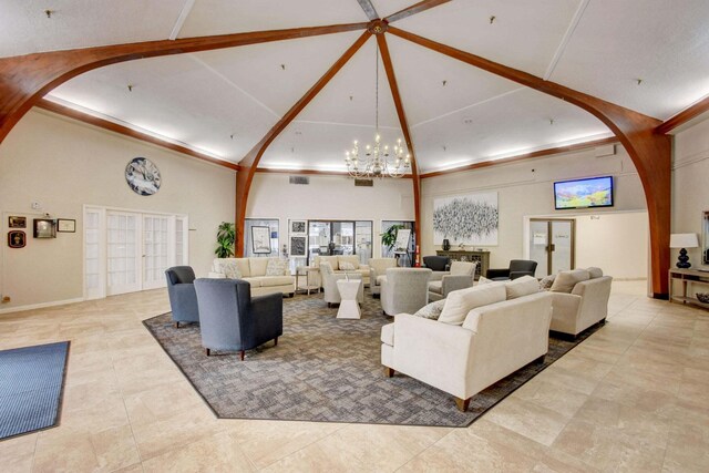 living room with an inviting chandelier, french doors, light tile patterned floors, and a towering ceiling