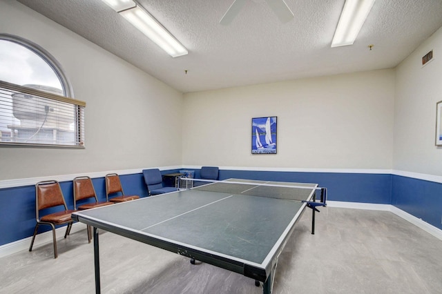 playroom featuring ceiling fan and a textured ceiling