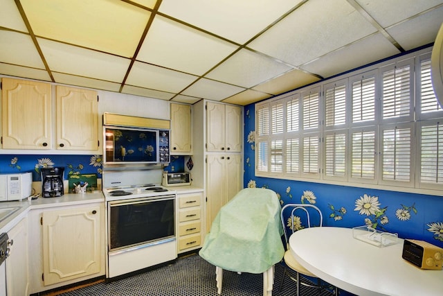 kitchen with a drop ceiling and white appliances