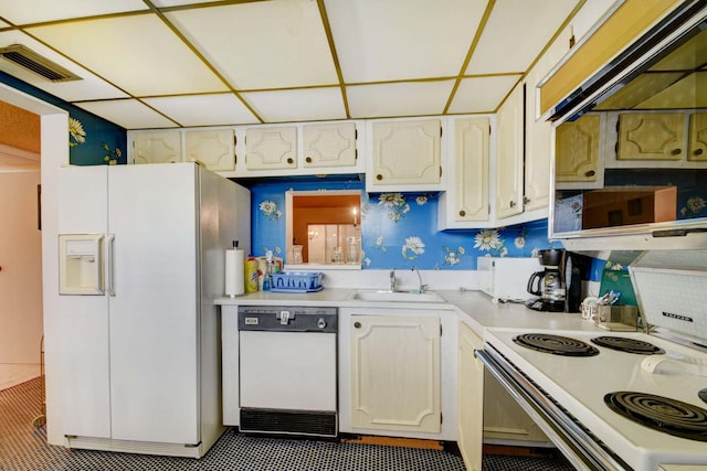 kitchen with white cabinetry, sink, and white appliances