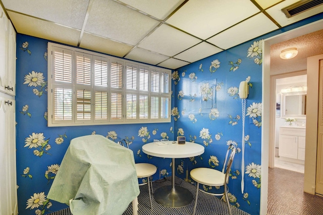 dining space featuring a drop ceiling