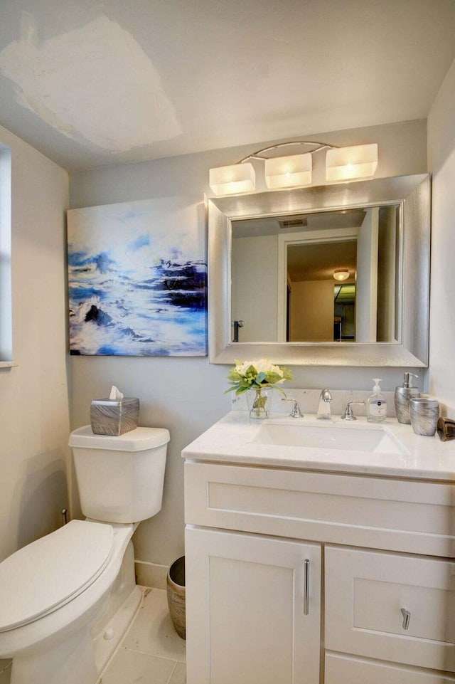 bathroom featuring vanity and toilet