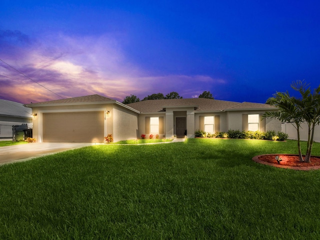 view of front of home featuring a garage and a lawn