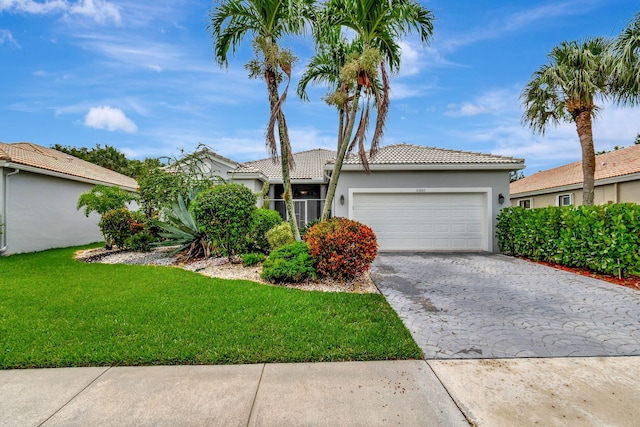 view of front facade with a front yard and a garage