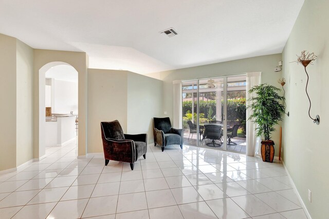 living room featuring light tile patterned floors and an inviting chandelier