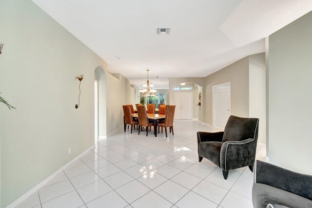 tiled living room with a chandelier