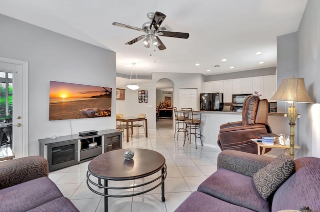 tiled living room with ceiling fan