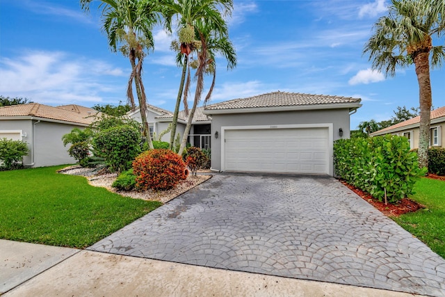 view of front of home with an attached garage, a front yard, decorative driveway, and stucco siding