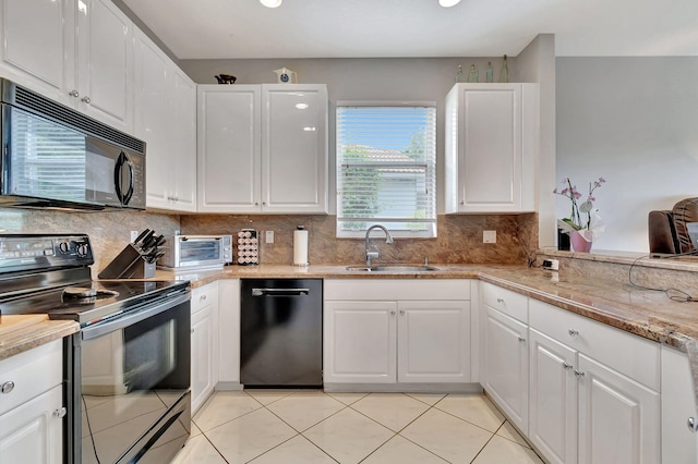 kitchen with black appliances, light tile patterned flooring, white cabinetry, and sink