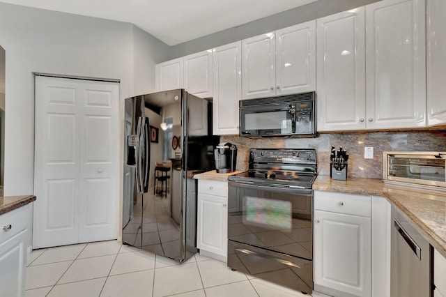 kitchen with black appliances, white cabinets, decorative backsplash, light tile patterned floors, and light stone counters