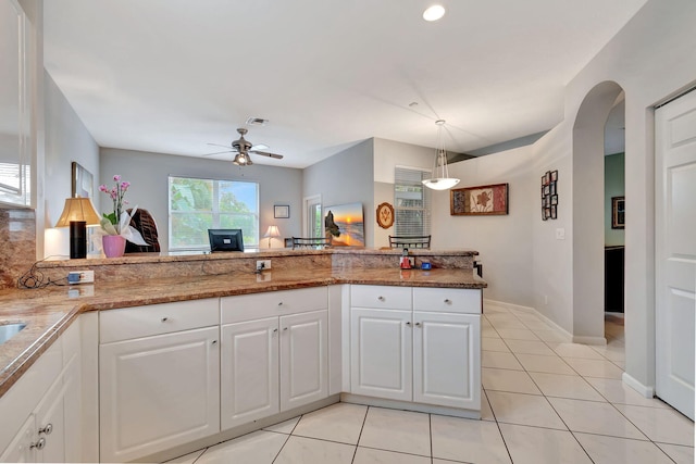 kitchen with white cabinets, decorative light fixtures, ceiling fan, and kitchen peninsula