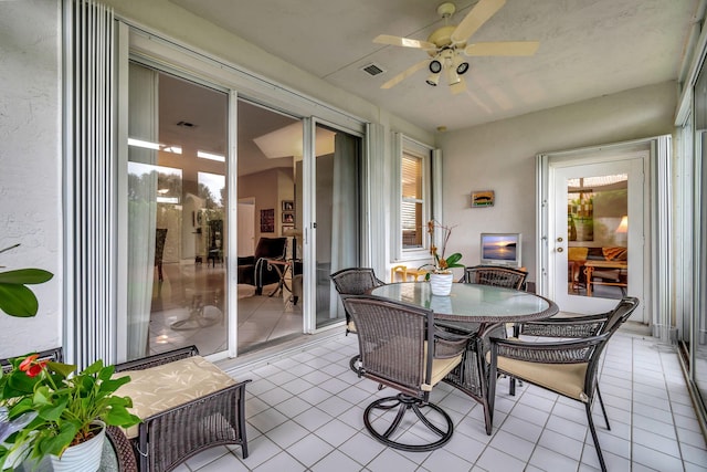 sunroom / solarium featuring ceiling fan