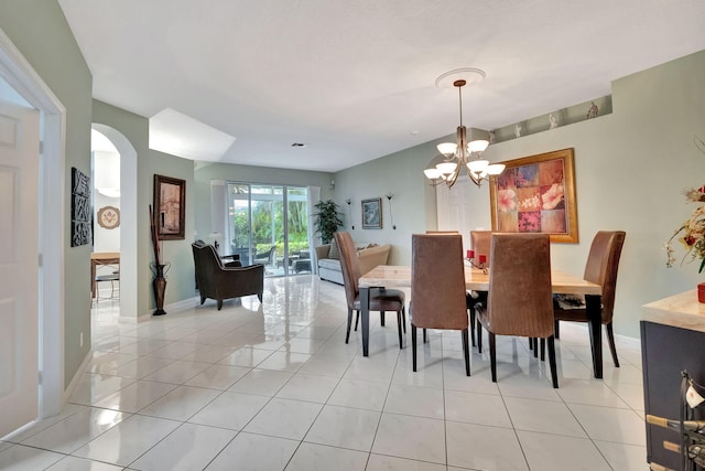 dining space featuring light tile patterned floors and a notable chandelier