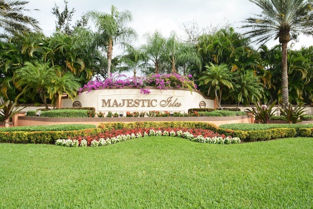 community sign featuring a lawn