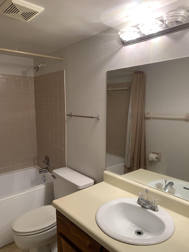 full bathroom featuring shower / bathtub combination with curtain, vanity, and toilet